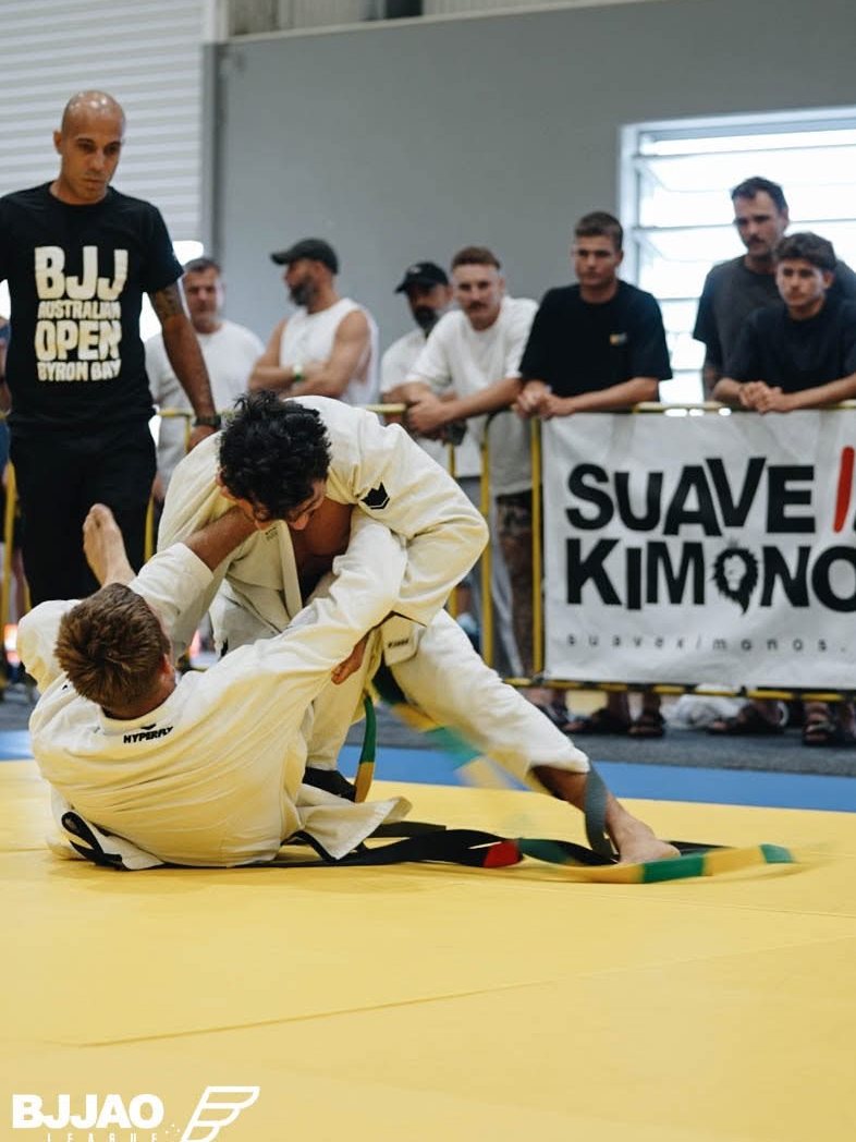 Two competitors scrambling in a Gi match at a BJJ Australian Open event