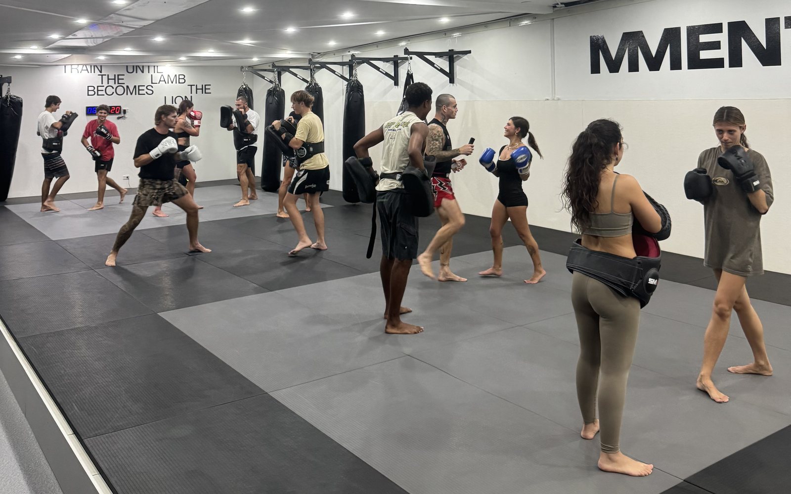 A Muay Thai class partnered up for pad work
